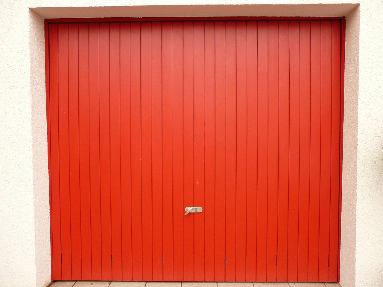Homeowner testing garage door balance by lifting it manually