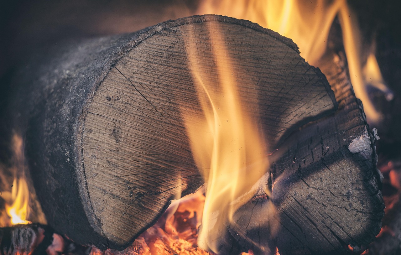 Arranging ceramic logs carefully inside a direct-vent gas fireplace firebox
