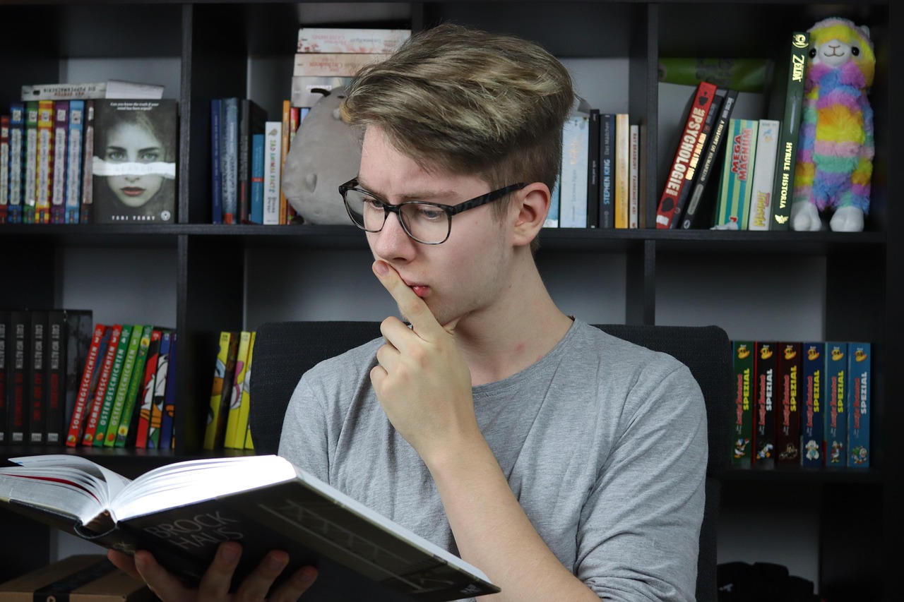 High school student studying with textbooks and a notebook at a desk