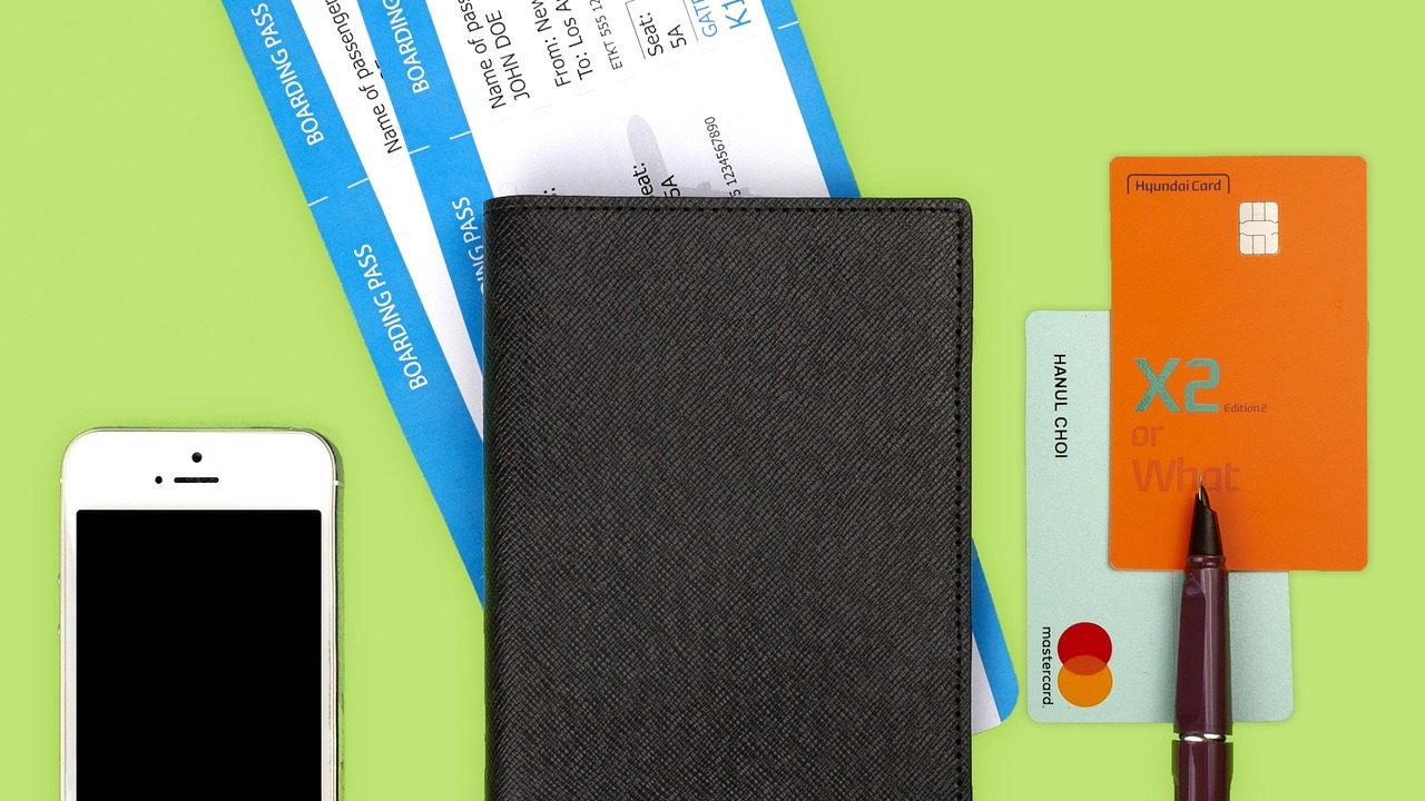 A teenager looking at passport and airline ticket before an international trip.