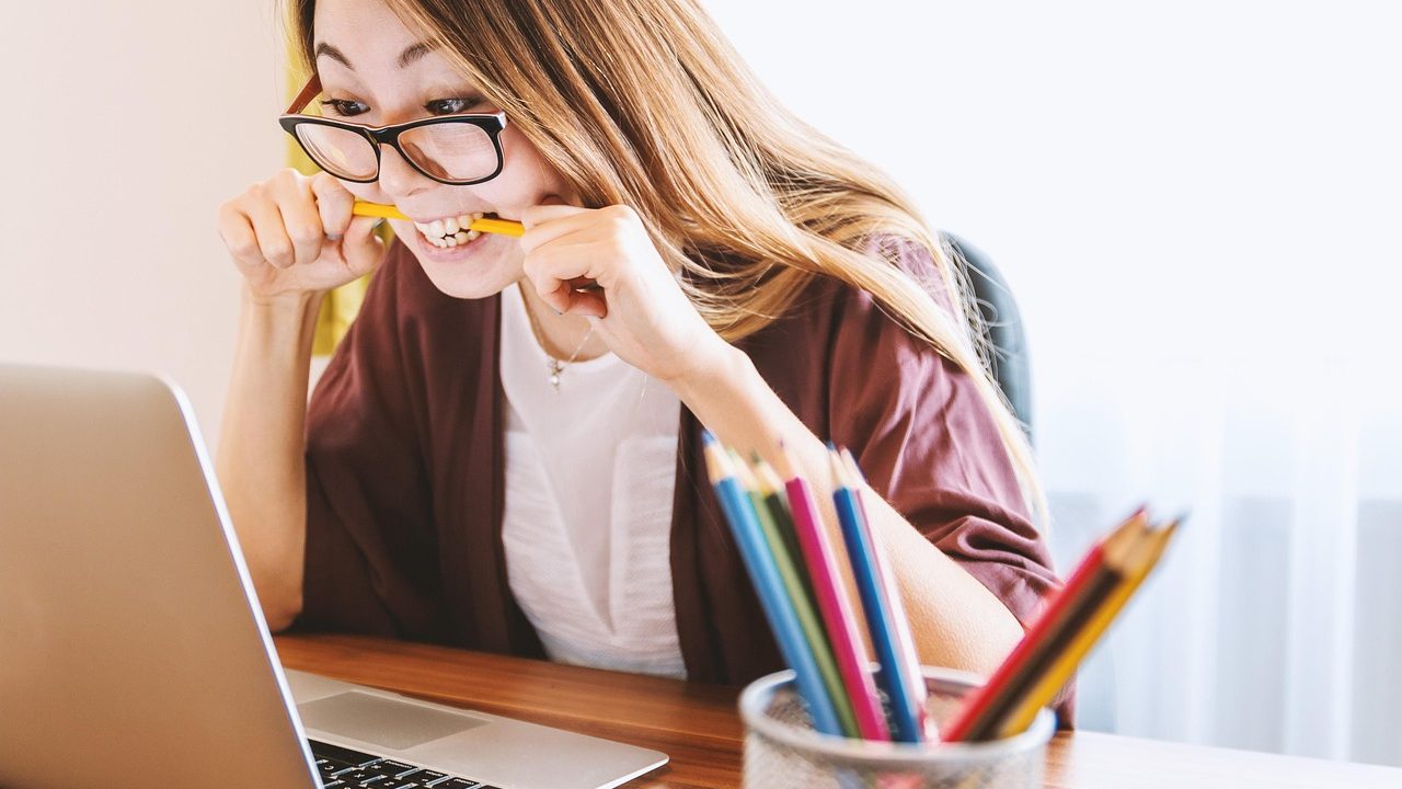 High school student studying with a laptop at a desk