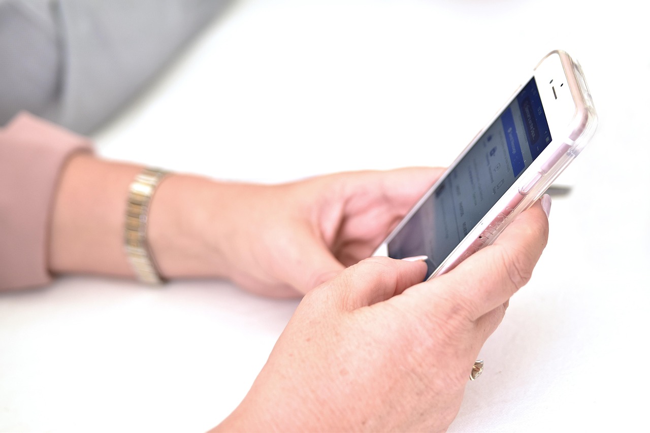 A close-up of a person checking a mobile banking app on their smartphone.