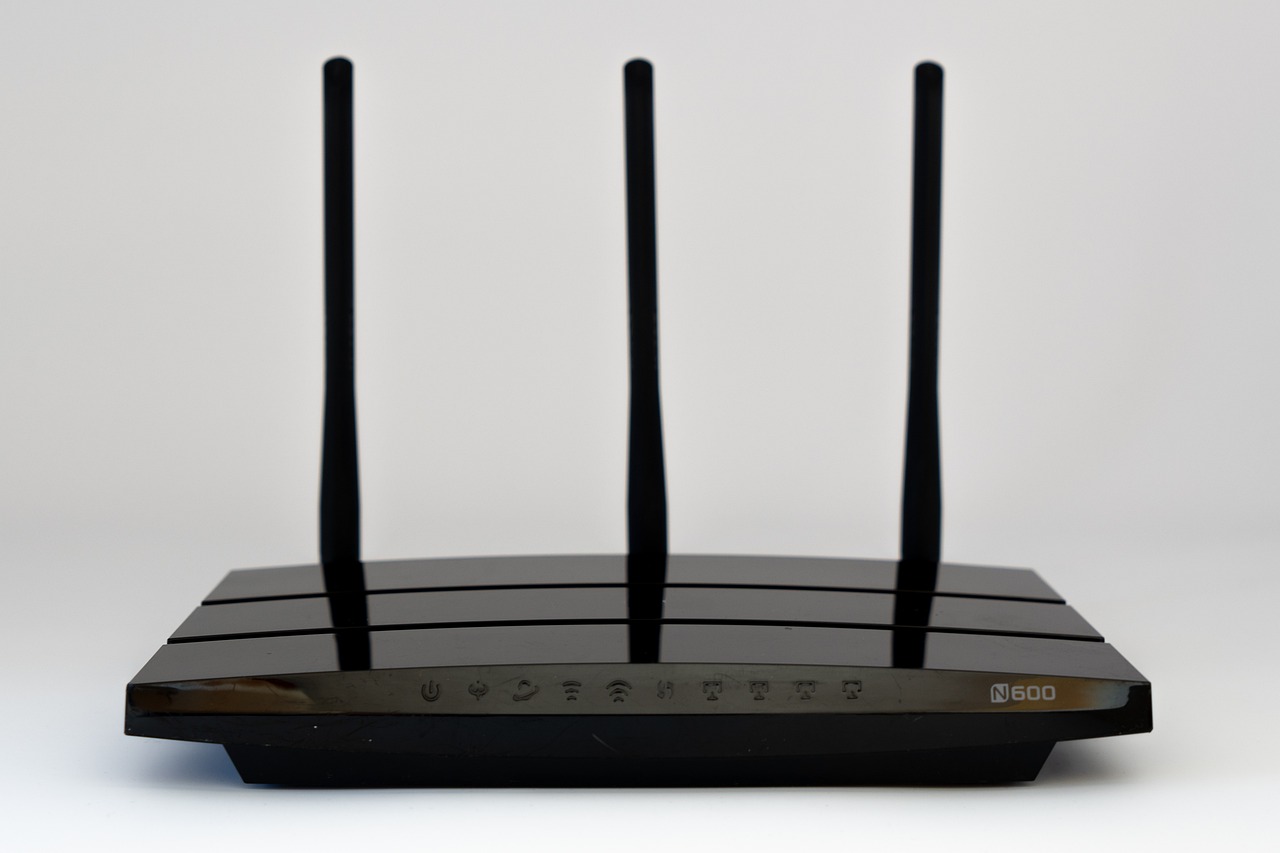 Internet modem and wireless router sitting on a home office desk.