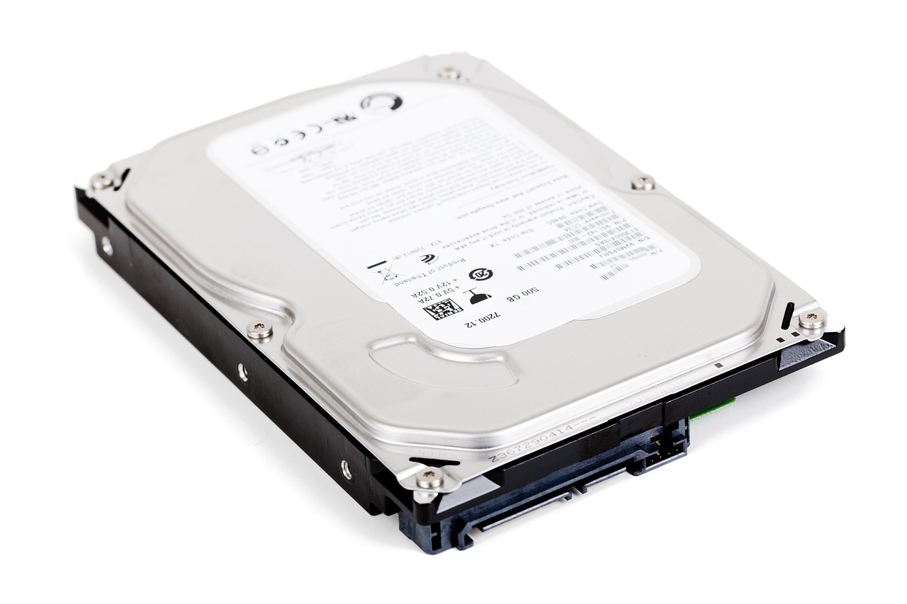 An external portable hard drive resting on a modern office desk.