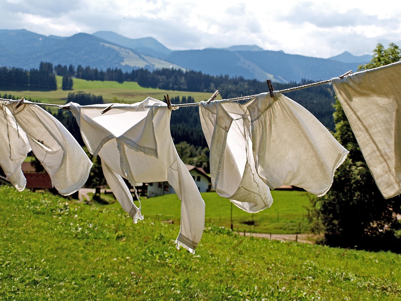 Clothes drying on a folding rack inside a small apartment living room.