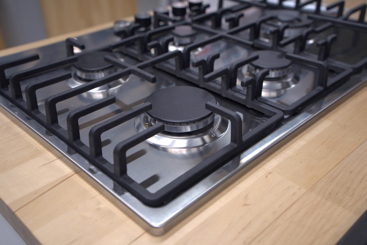 Traditional electric coil burner glowing red on a kitchen stove.
