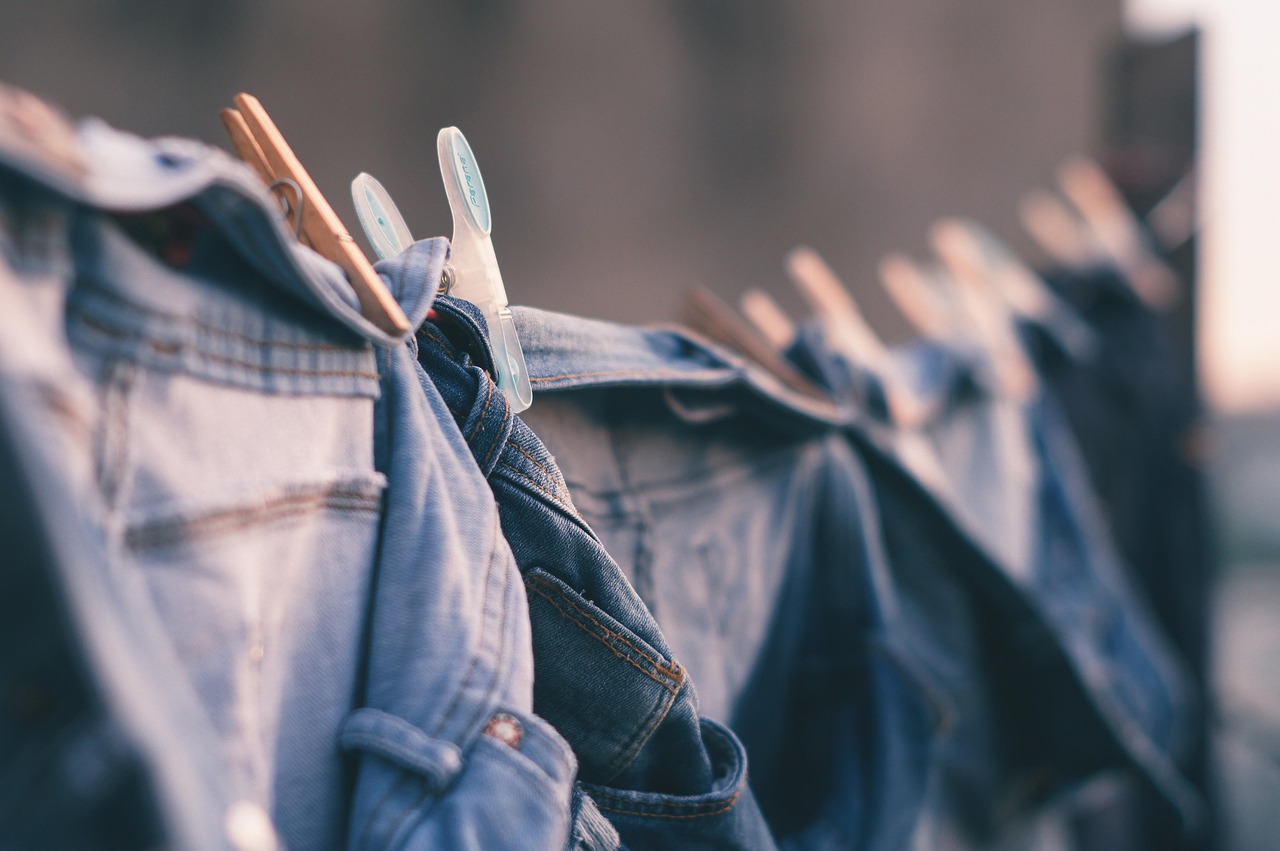 Wet garments hanging on an indoor drying rack in a small room.