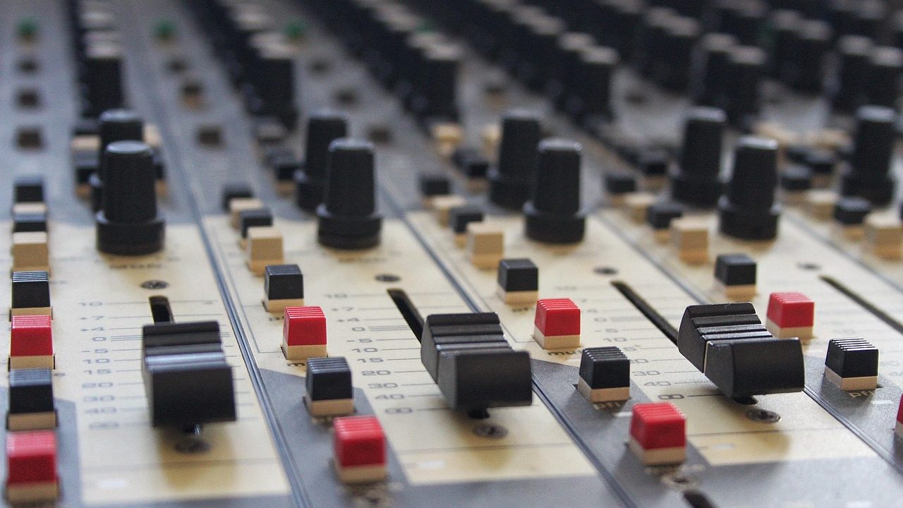 Close-up of a professional mixing console and audio interface in a recording studio