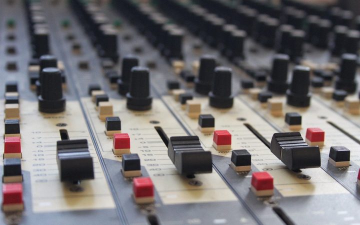 Close-up of a professional mixing console and audio interface in a recording studio