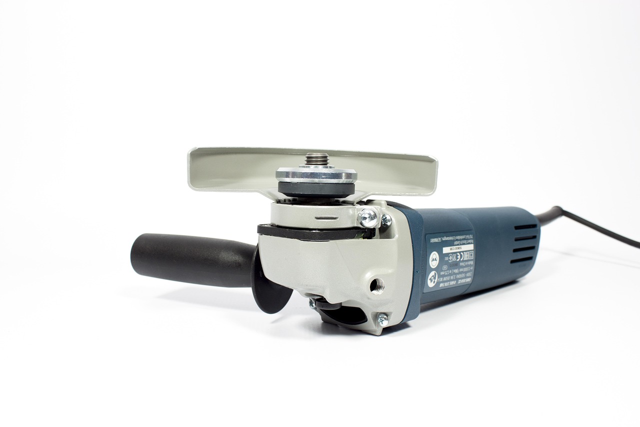 A technician inspecting the internal components of a disassembled cordless power tool.