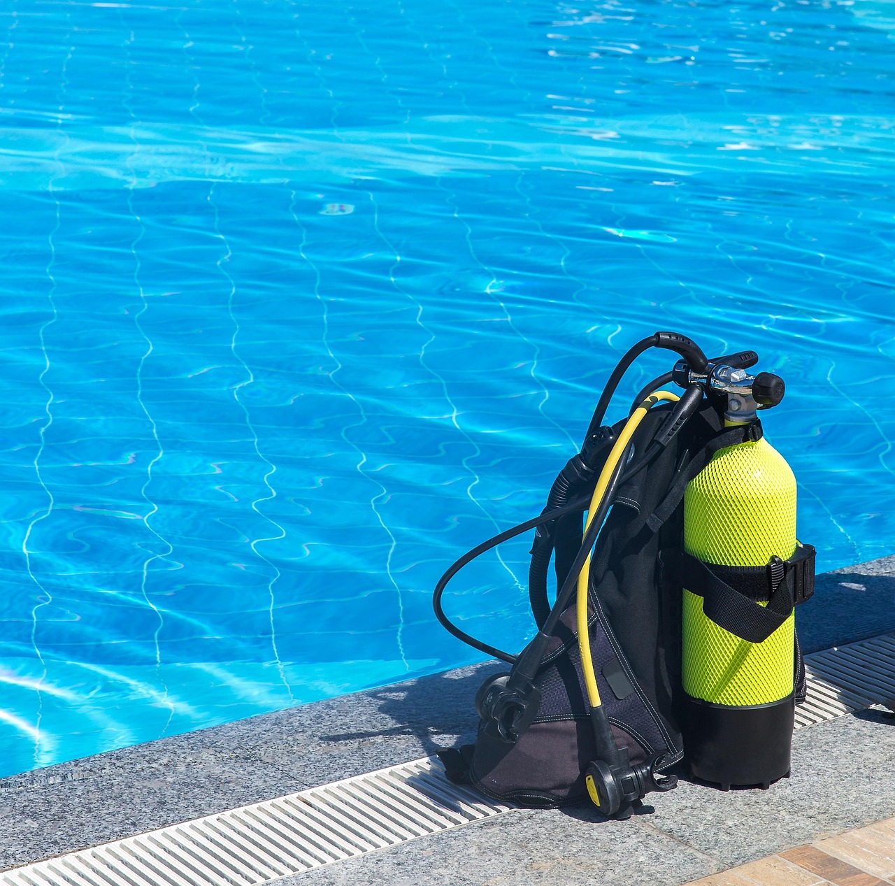 A technician inspecting internal robotic pool cleaner parts on a workbench.