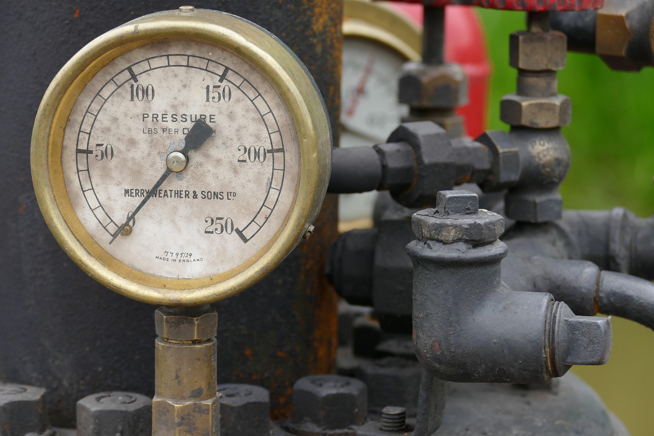 Close up of residential gas meter and supply pipes on exterior wall