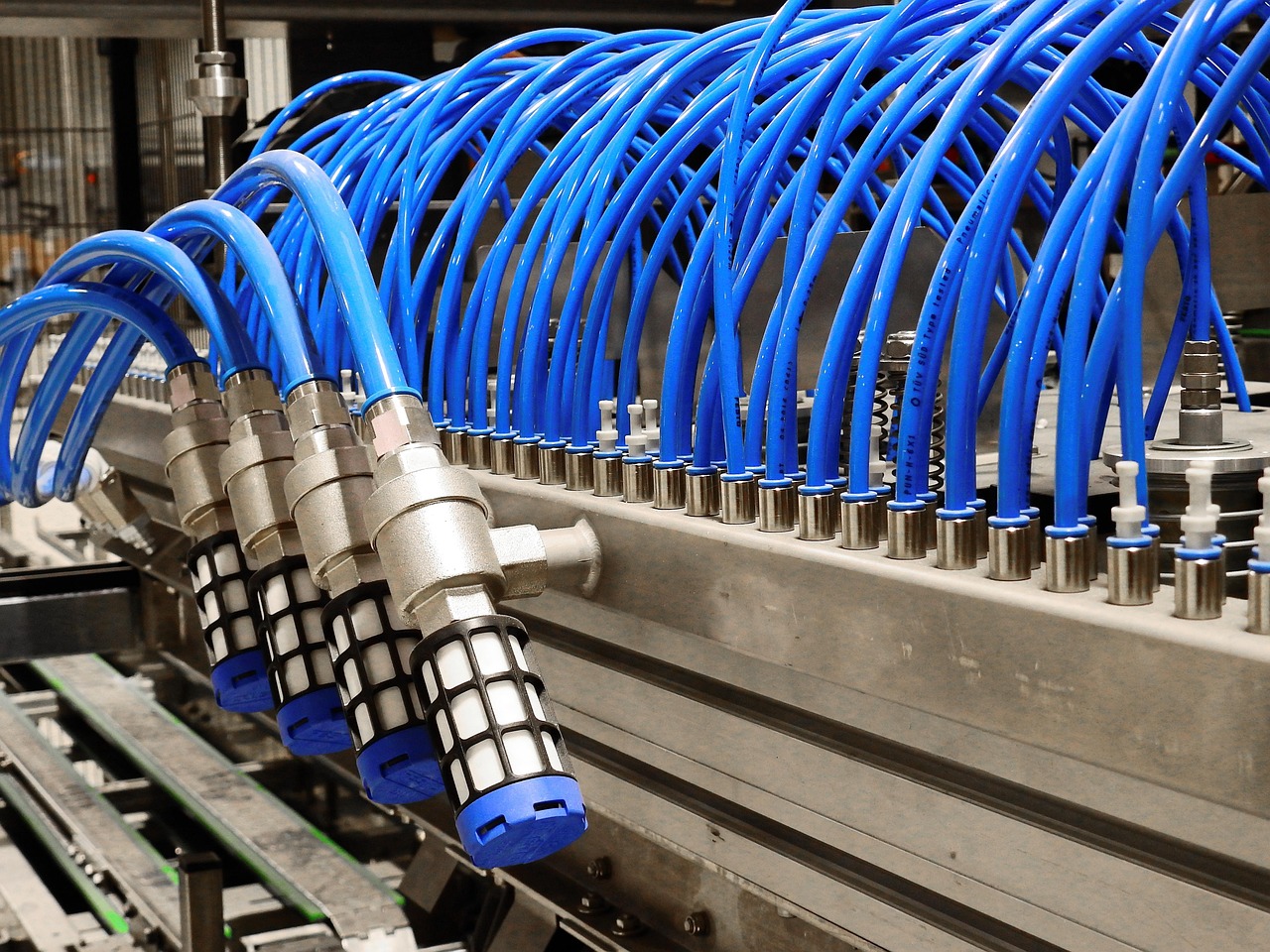 Close-up of aluminum electrostatic precipitator collector blades being rinsed with a garden hose.