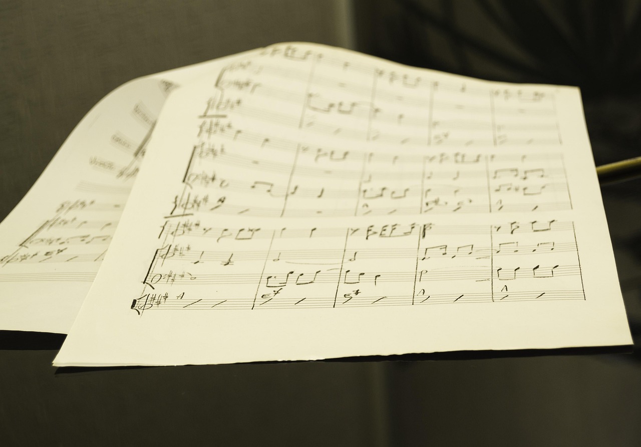 Sheet music and instrument on a stand during a music rehearsal