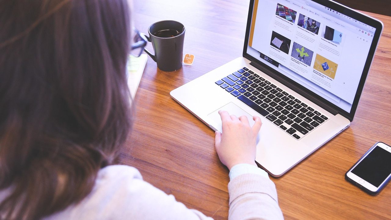 College student reviewing digital textbook billing statements on a laptop