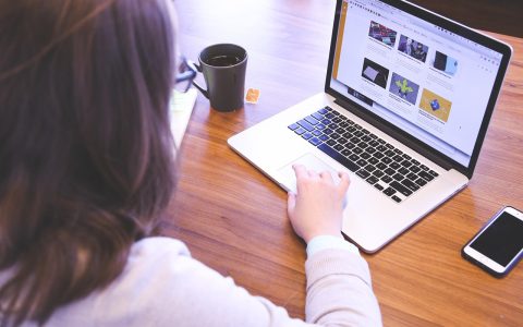 College student reviewing digital textbook billing statements on a laptop