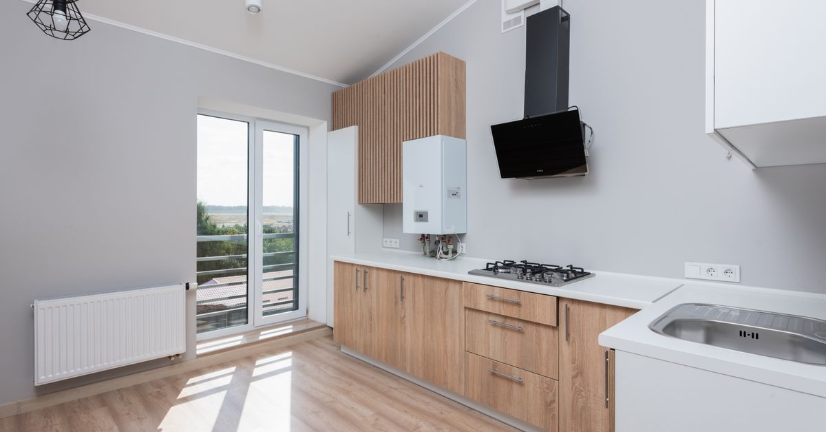 Contractor measuring cabinetry clearance for a built-in appliance installation