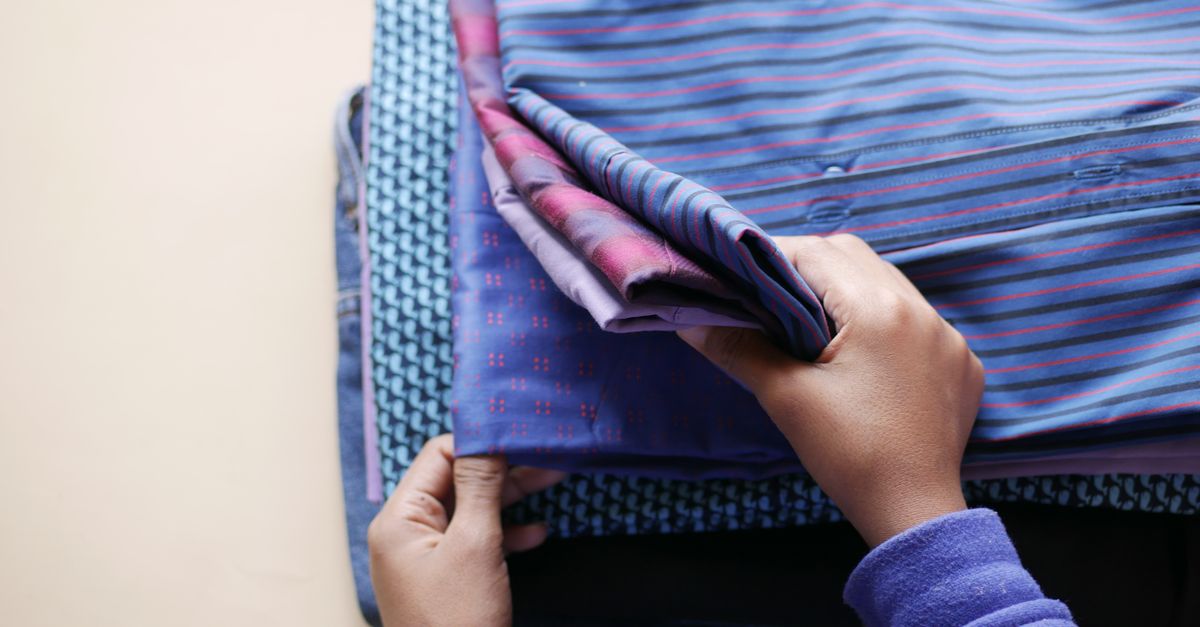 Folding activewear clothes on a wooden table