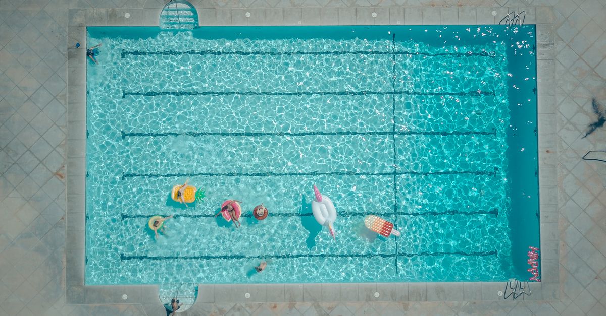 Crowded public municipal swimming pool on a warm summer afternoon