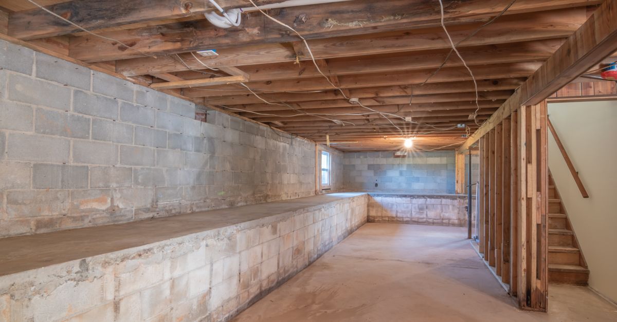A clean residential sump pump basin installed inside a crawlspace floor.