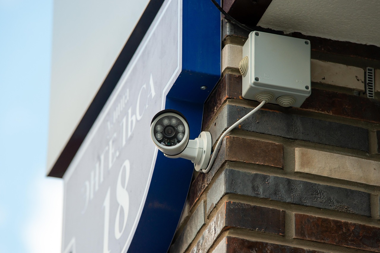 Using a thermal imaging device to scan a room corner for cold air intrusion.