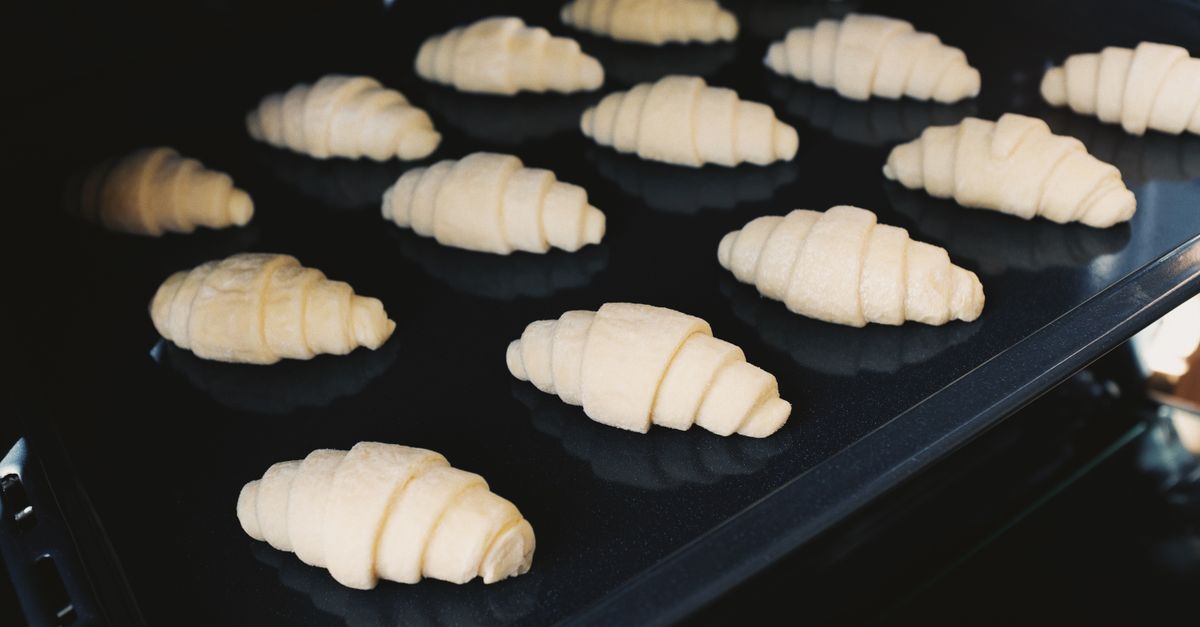 Baking sheets inside a brightly lit electric convection oven.