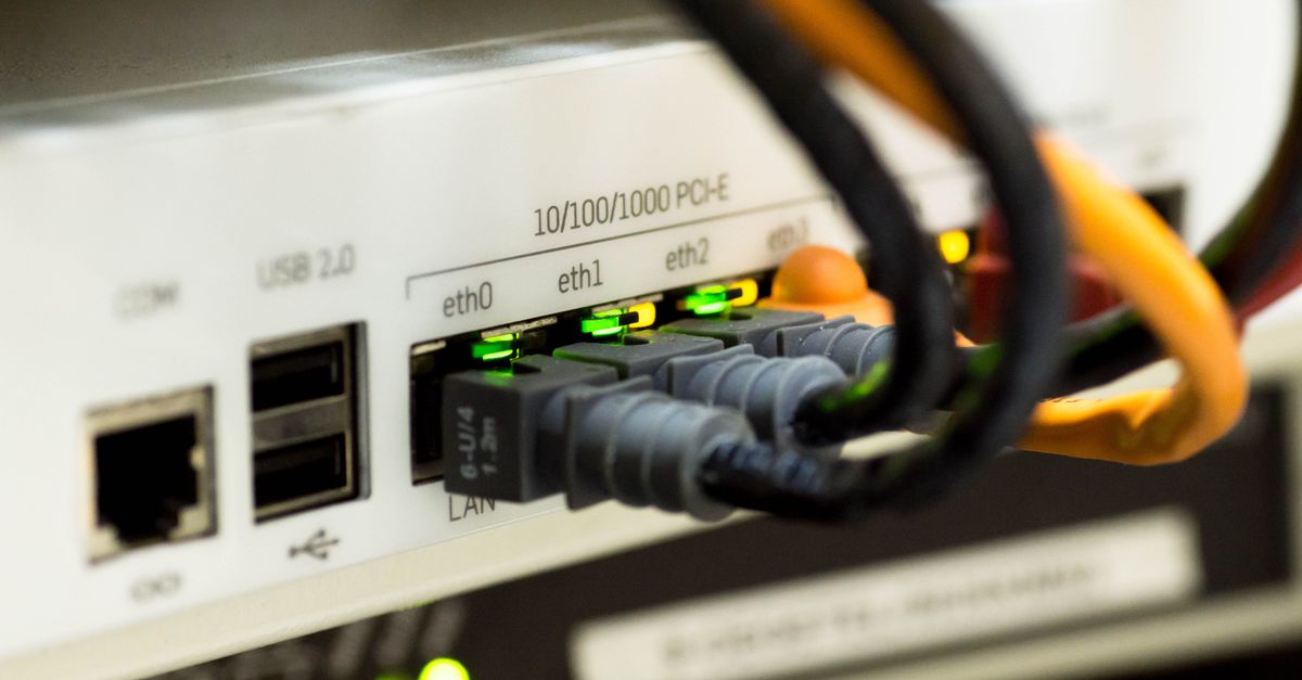 Close-up of network router and ethernet cables plugged into a home office switch.