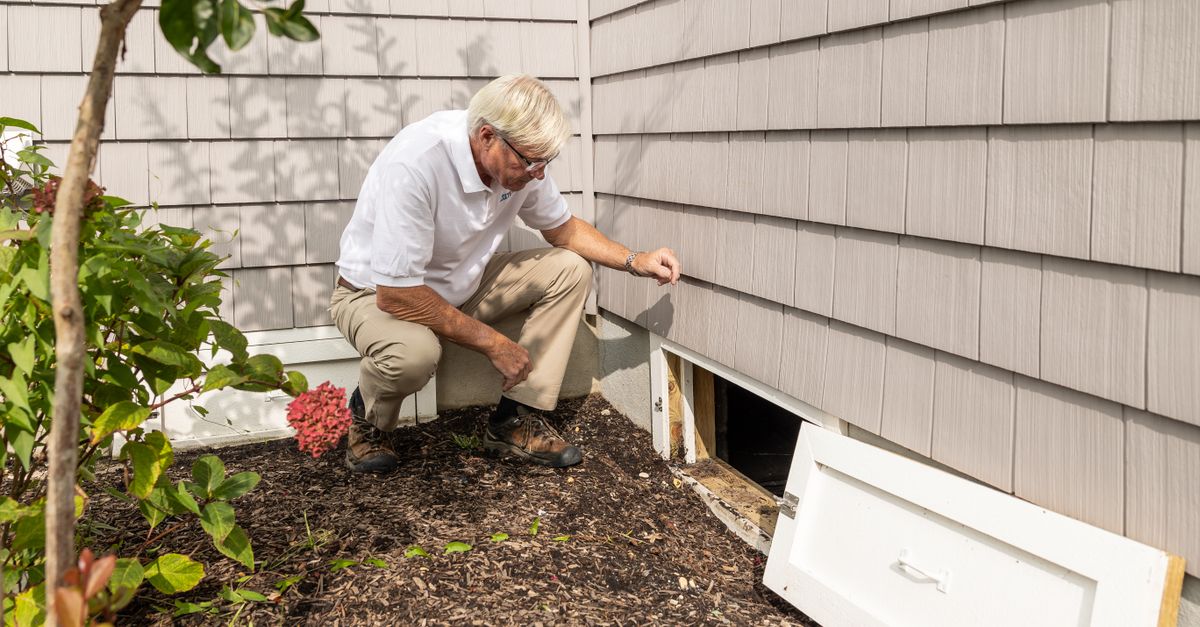 A real estate appraiser taking notes outside a residential property.