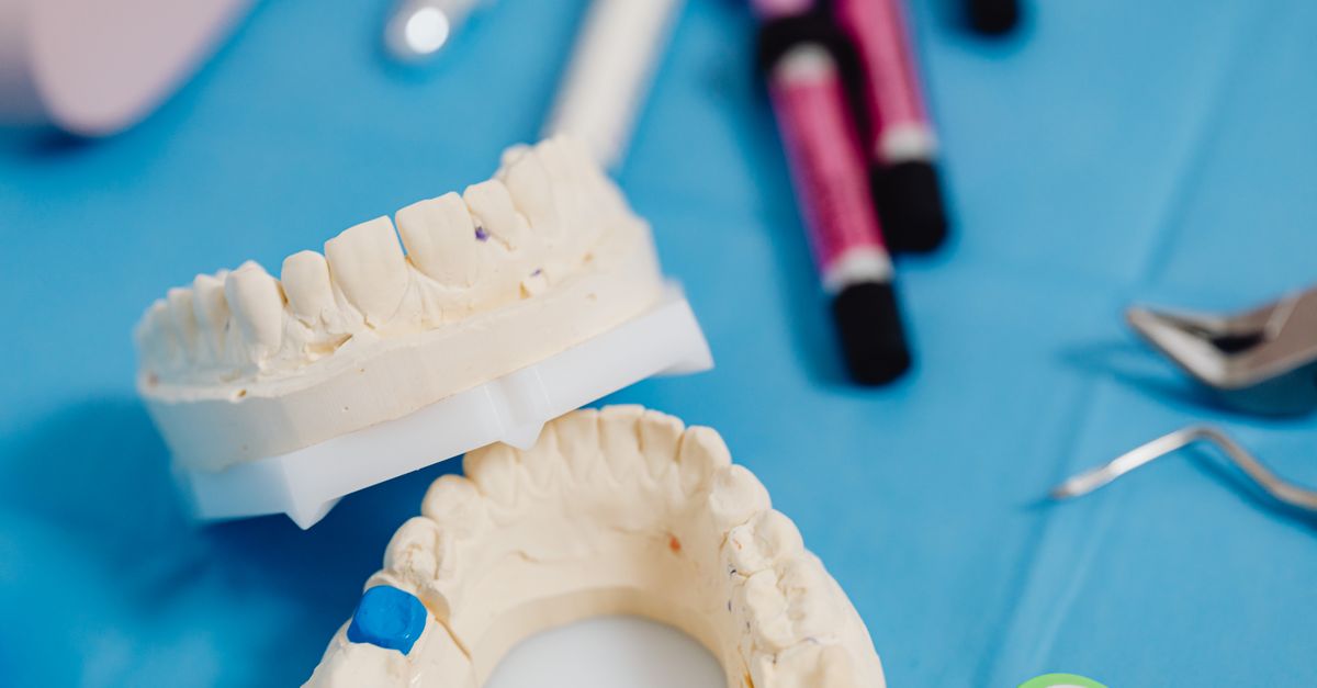 Orthodontist explaining a dental model to parents