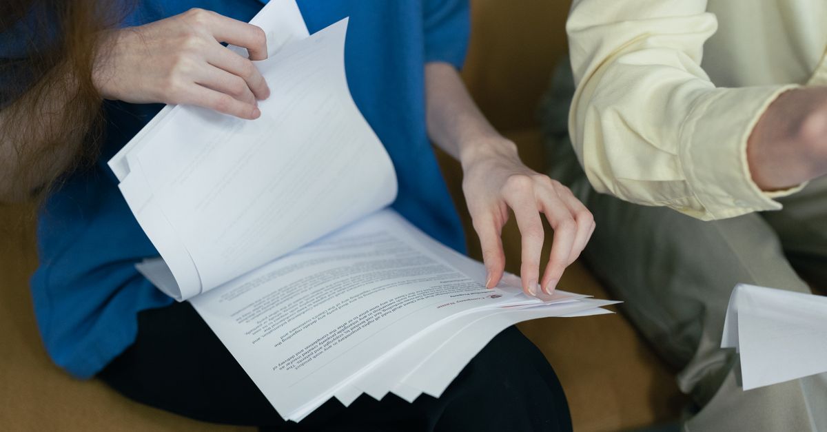 Parents reviewing financial paperwork at a desk