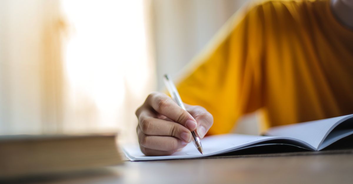 Close-up of a professional taking handwritten notes and mapping out a strategic plan