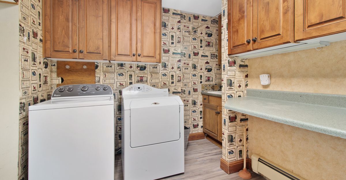Compact ventless laundry unit installed in a small apartment closet