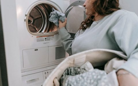 Front load washing machine and dryer stacked in a modern laundry room