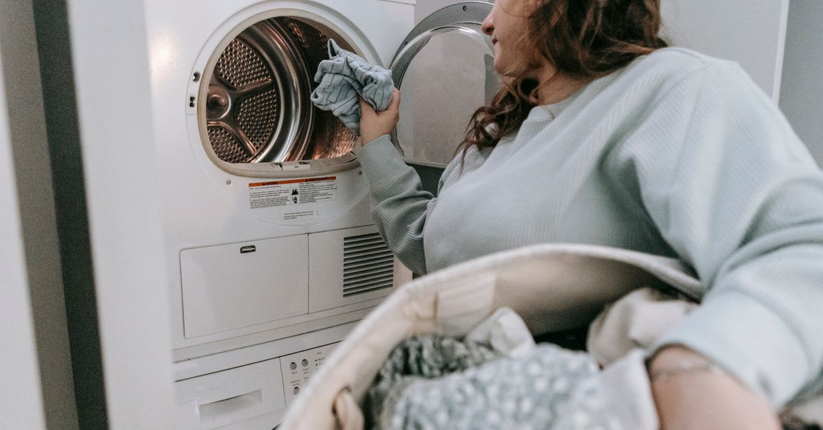 Front load washing machine and dryer stacked in a modern laundry room