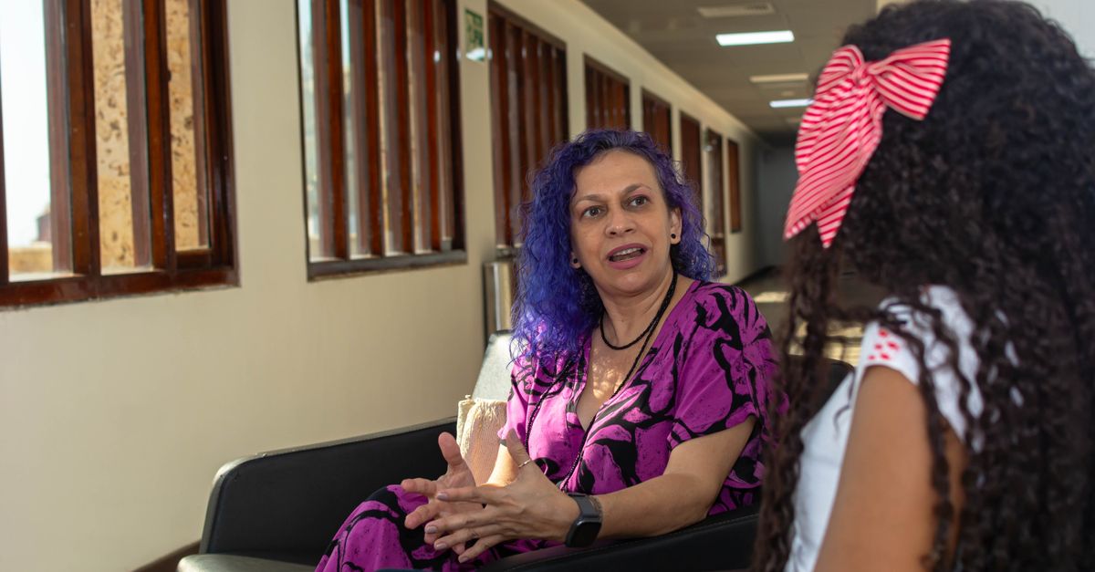 High school student having a discussion with a school guidance counselor in an office