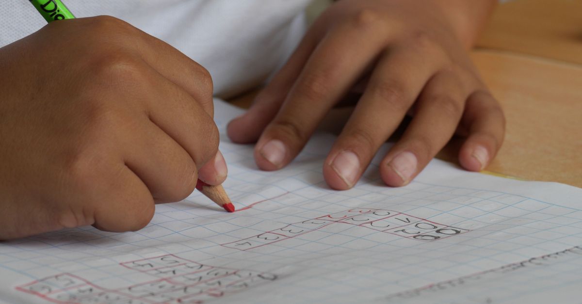 High school student tracking community service hours in a notebook
