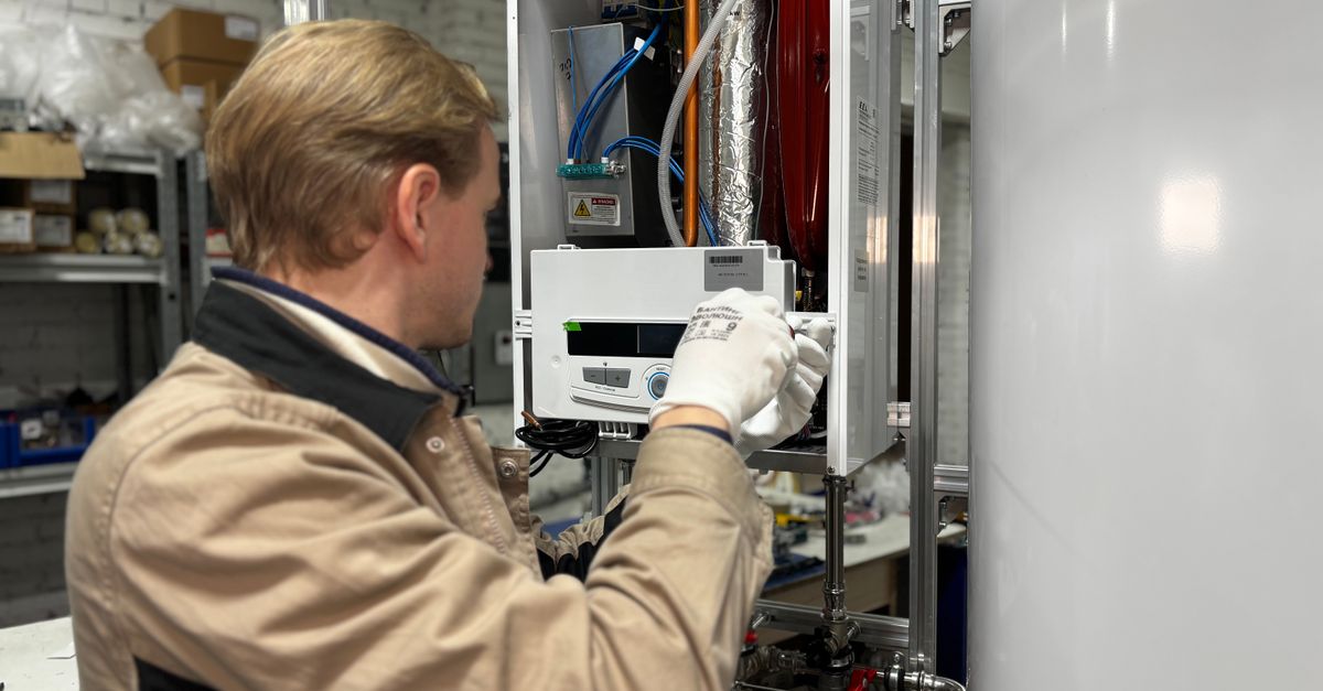 A technician servicing a residential HVAC heating unit.