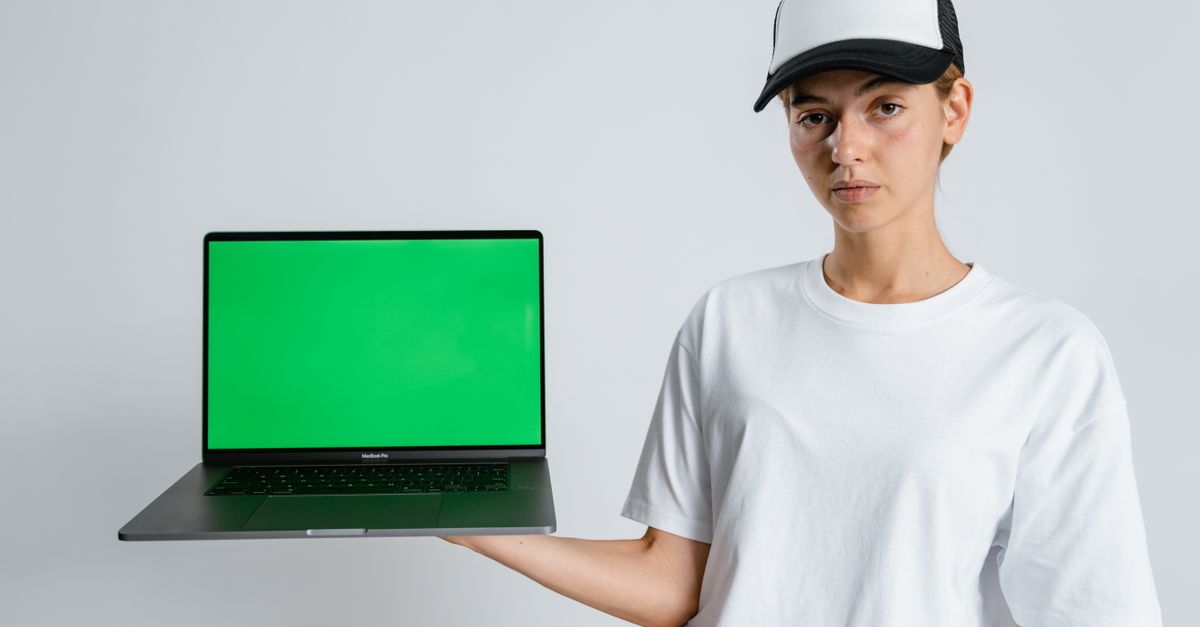 Person closing a laptop computer after managing online account settings.