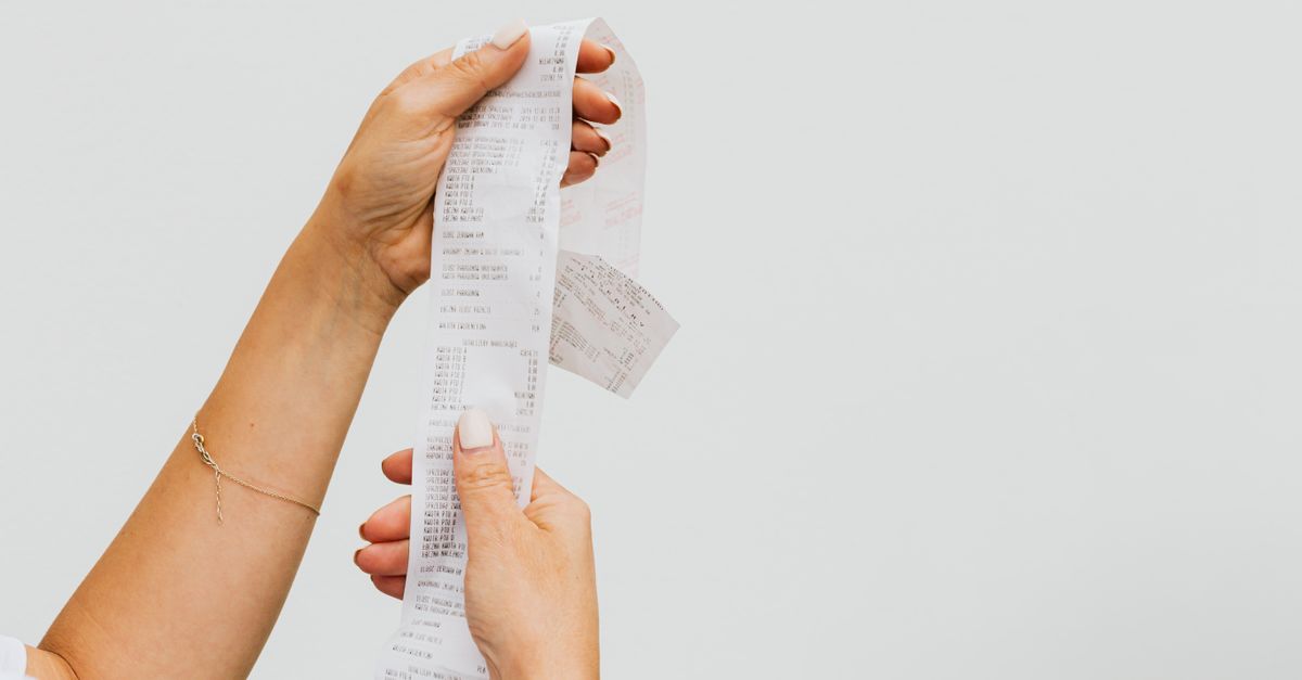 Traveler reviewing a hotel invoice for hidden fees