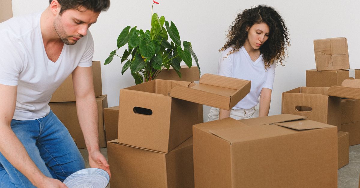 Cardboard moving boxes stacked in a living room during relocation