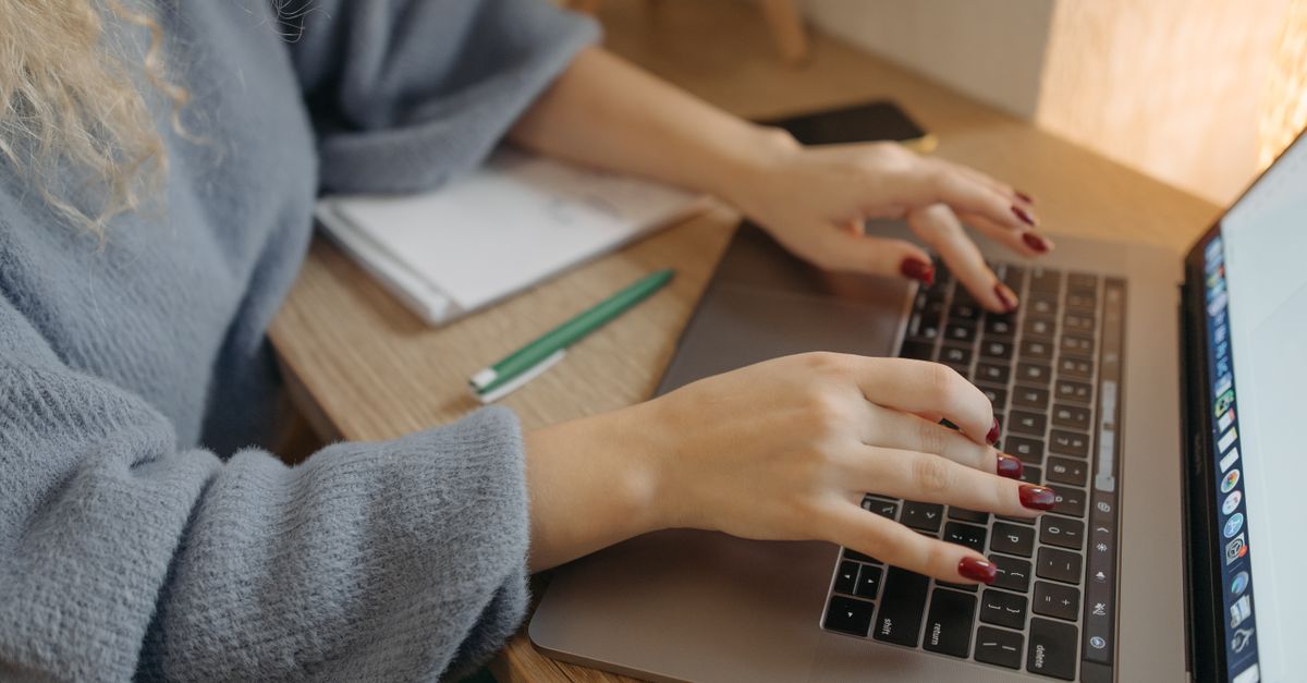A person reviewing state agency guidelines on a laptop computer.