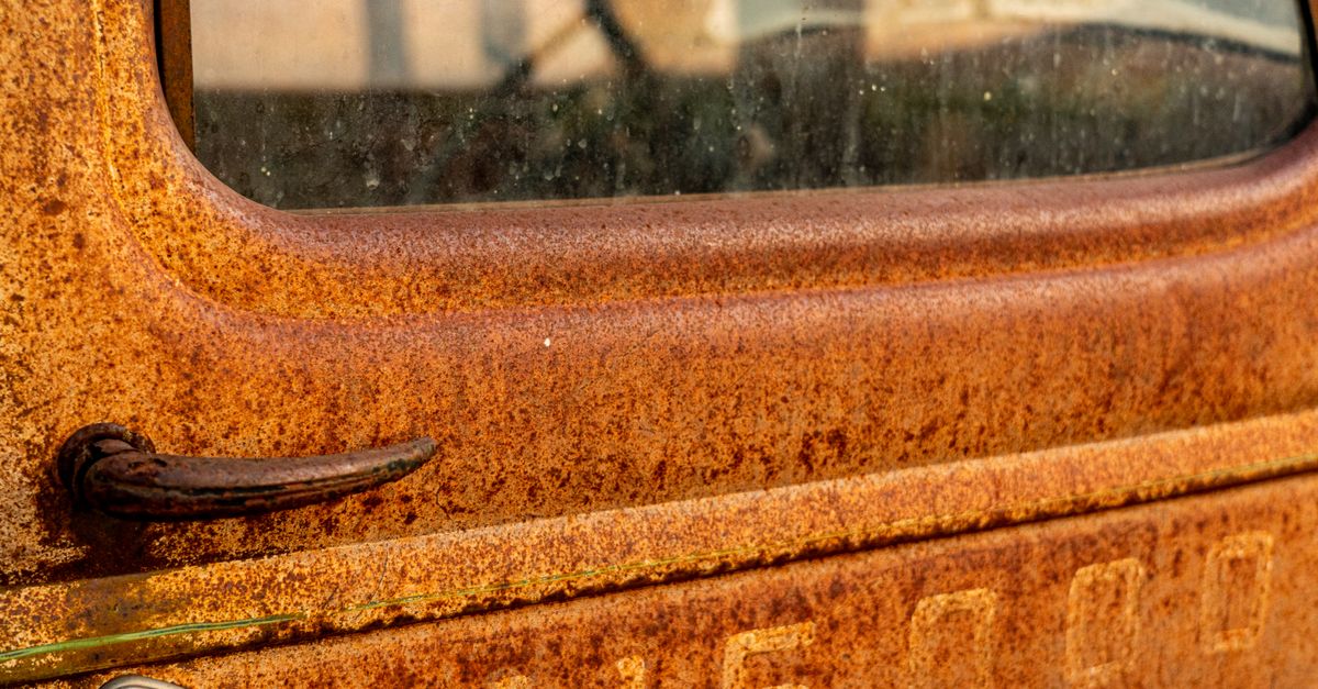 Screwdriver removing a set screw from a casement window crank handle