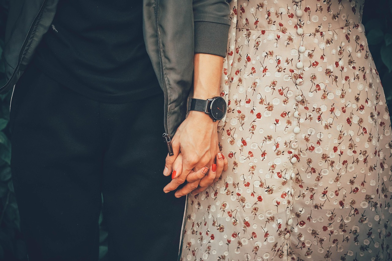 Hands holding a certified state government paper document with a raised seal.