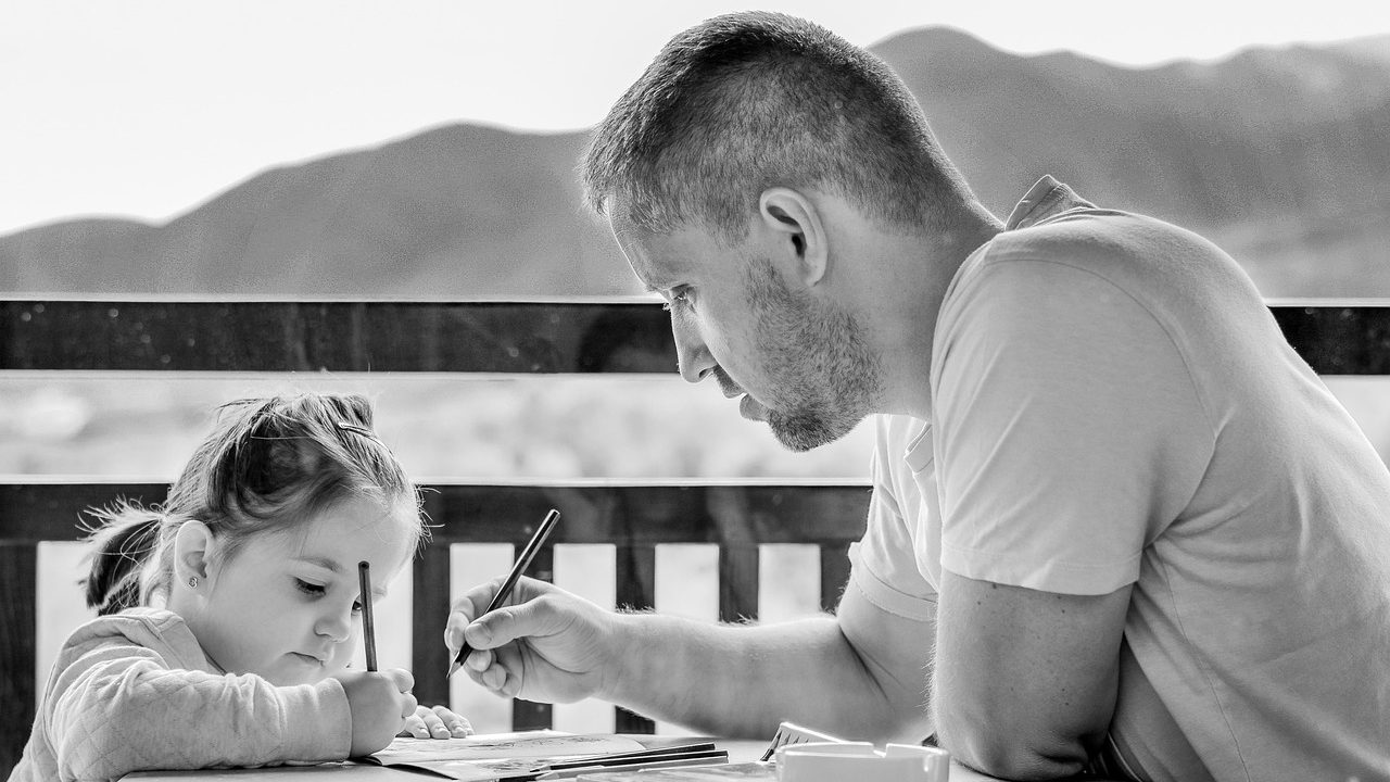 Family reviewing health insurance documents and financial paperwork at a kitchen table