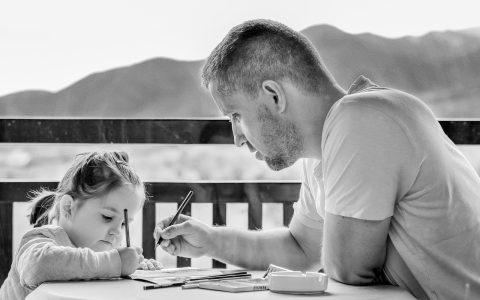 Family reviewing health insurance documents and financial paperwork at a kitchen table