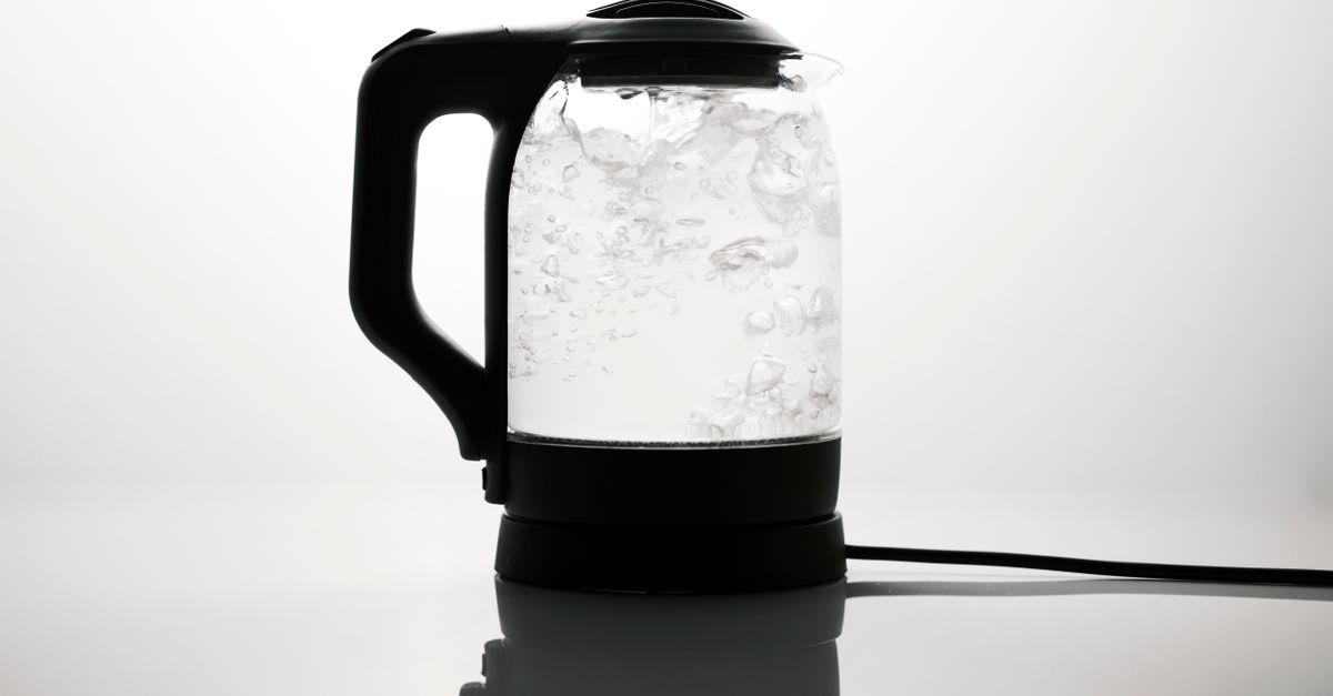 An electric kettle heating water on a kitchen counter.