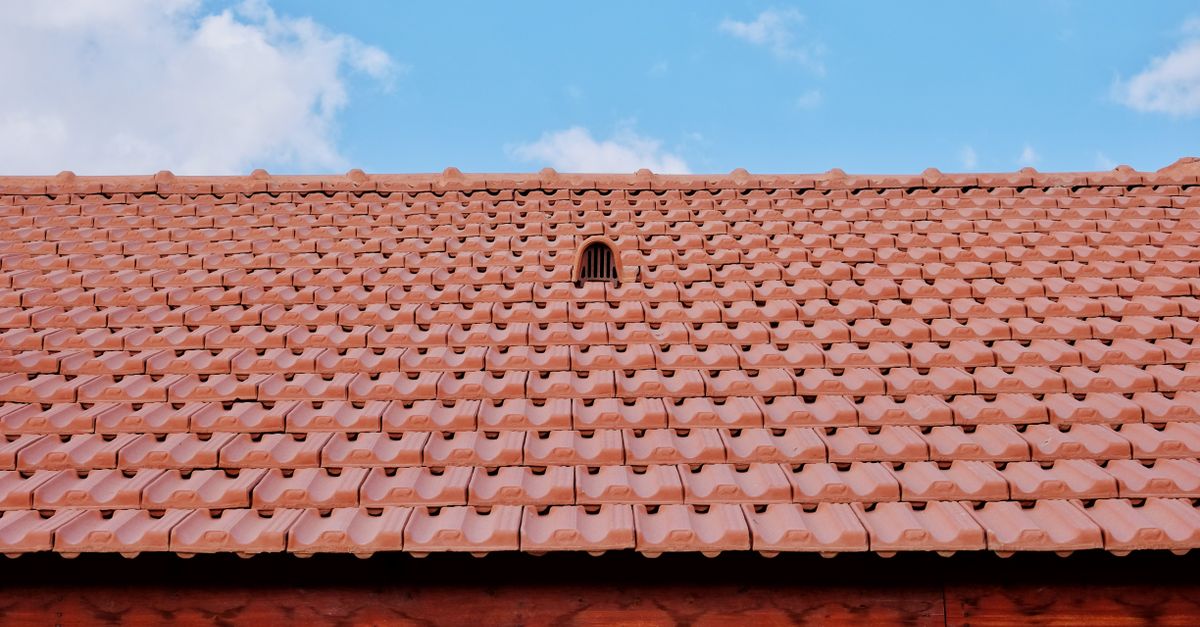 Metal exhaust roof cap vent installed on a shingled residential roof