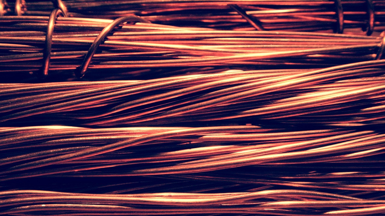 Heavy copper grounding wire running down the exterior brick wall of a house