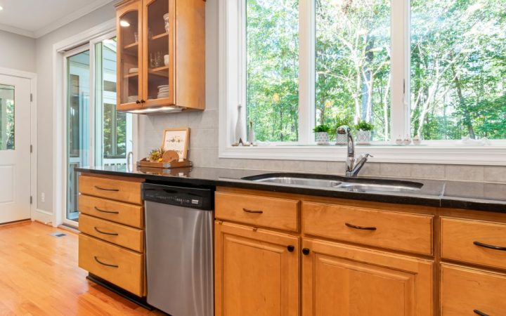 Modern kitchen featuring custom cabinetry with an integrated panel-ready dishwasher.