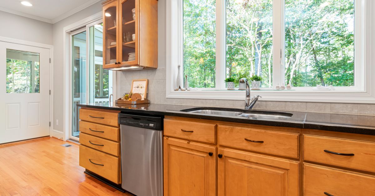 Modern kitchen featuring custom cabinetry with an integrated panel-ready dishwasher.